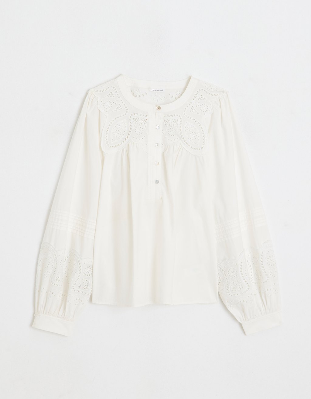White embroidered poplin blouse with long sleeves on a white background
