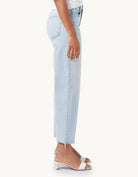 Light blue high-rise, wide-leg jeans worn by a person on a white background