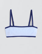 Light blue ribbed bikini top with contrast navy trim on a light gray background